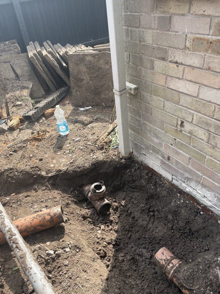 Excavated drainage trench and old broken paving cleared during the Chestnut Drive garden rebuild