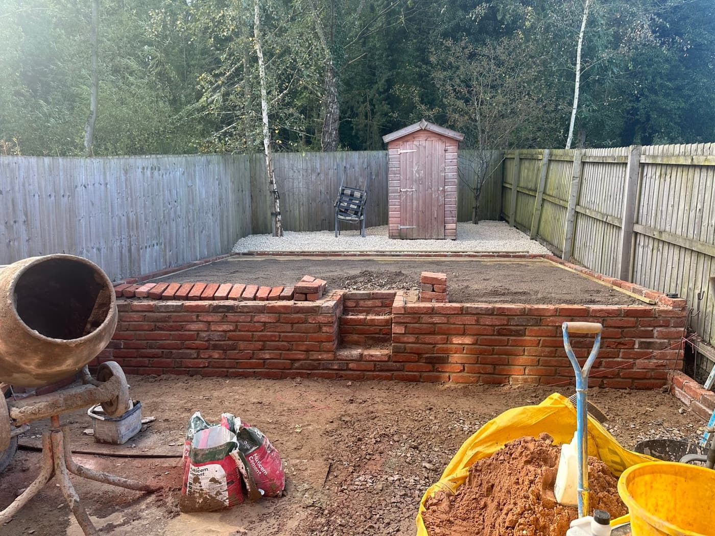 Brick retaining wall and gravel base under construction, forming the new terrace levels on the Forge Lane, Congleton project
