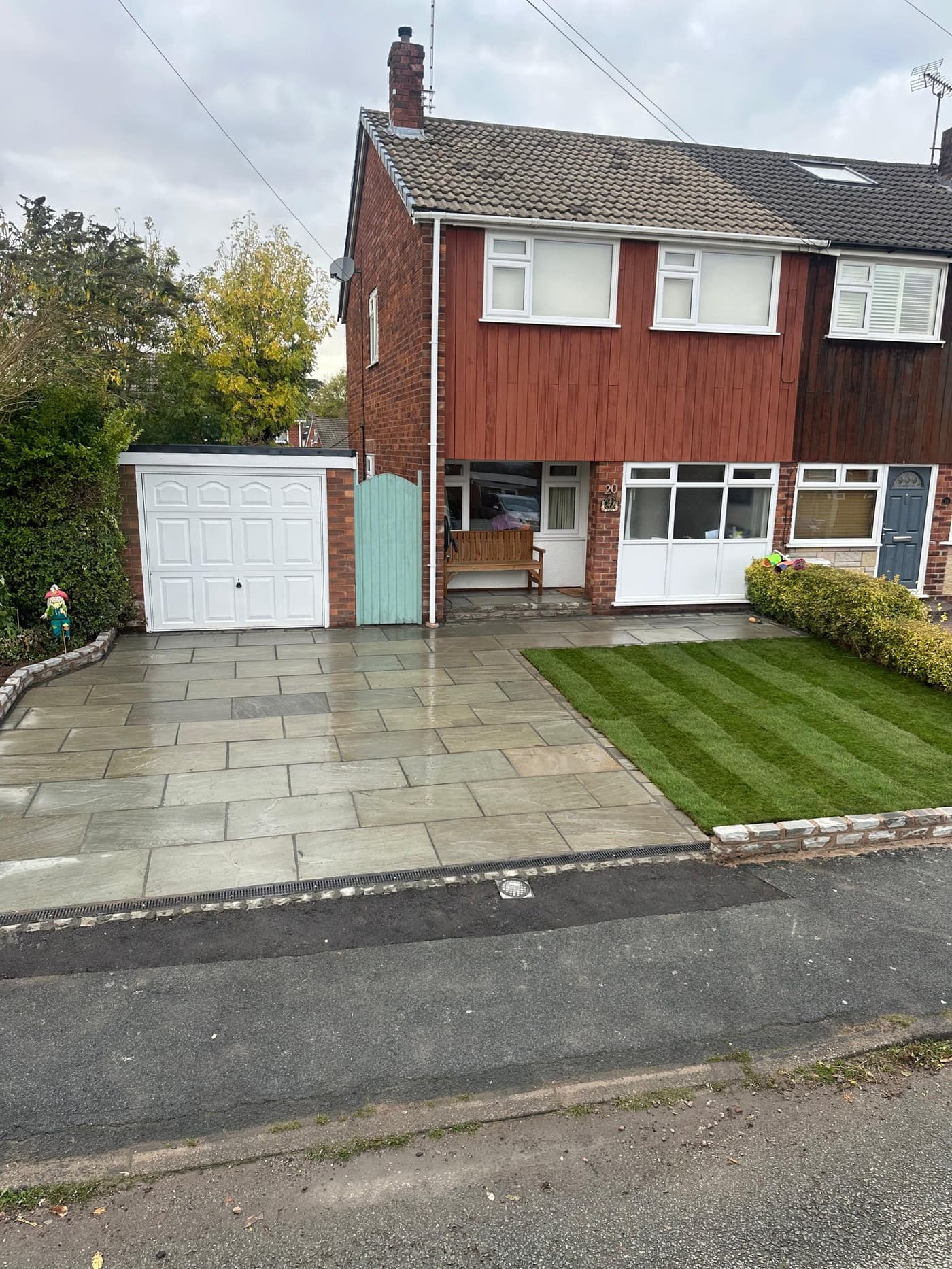 Before shot of a cracked, weed-strewn concrete driveway in Knutsford ahead of its Indian stone rebuild